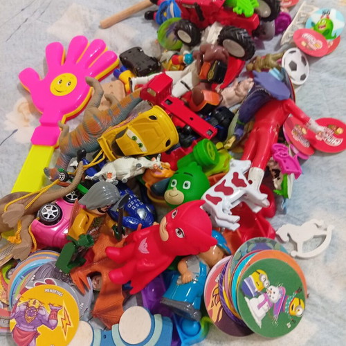 Box of various used children's toys including pop-it and wooden drum