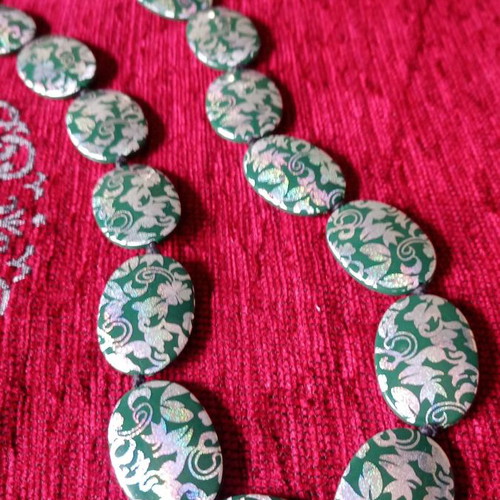 Acrylic green necklace used with holographic silver floral details