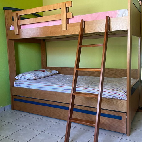 Wooden bunk bed with third sliding bed and mattresses like new