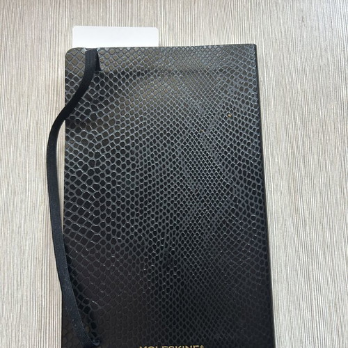 Moleskine black notebook with embossed cover