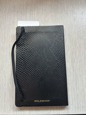 Moleskine black notebook with embossed cover