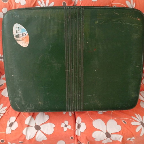 Vintage suitcase used with dark green color and quilted lining