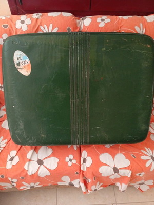Vintage suitcase used with dark green color and quilted lining