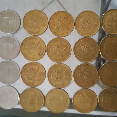 Collection of used 500 and 100 drachma coins with Vergina Sun