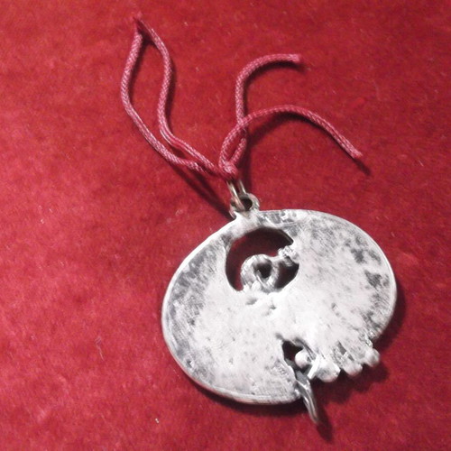 Metal round gouri charm with pomegranate decoration used, silver color