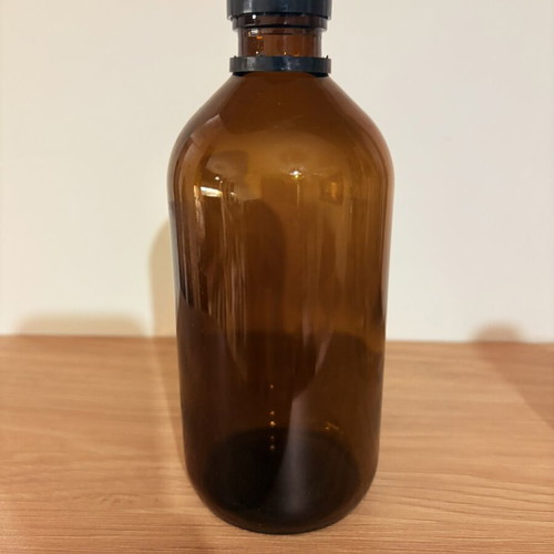 Brown glass pharmacy-style bottle with cap