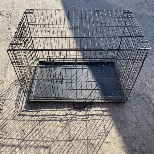 Dog crate used for a large dog with two doors and cleaning tray