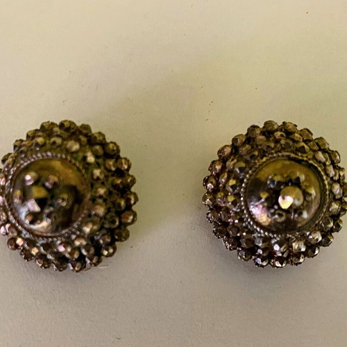 Vintage clip-on earrings with embossed marcasite-style details, used