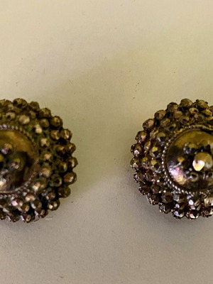 Vintage clip-on earrings with embossed marcasite-style details, used
