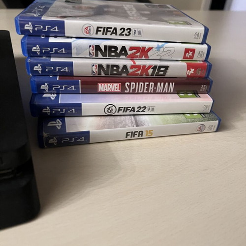 PS4 Slim 500GB console with 2 controllers and 6 games