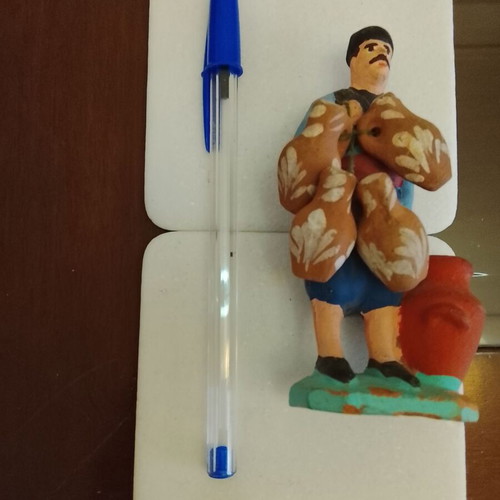 Traditional handmade clay figurine of a villager used