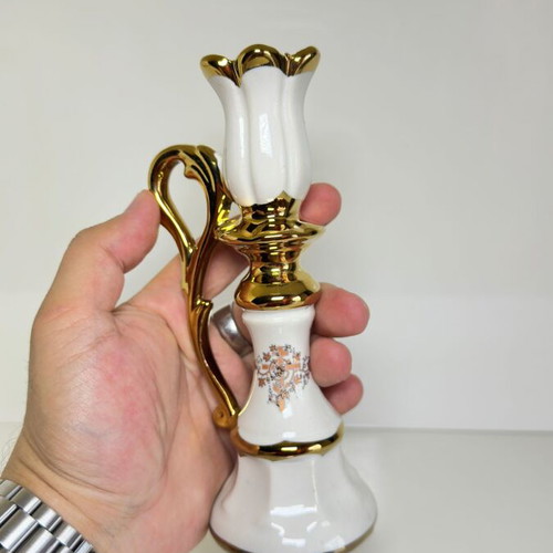 Ceramic candlestick with gold details and floral cross design