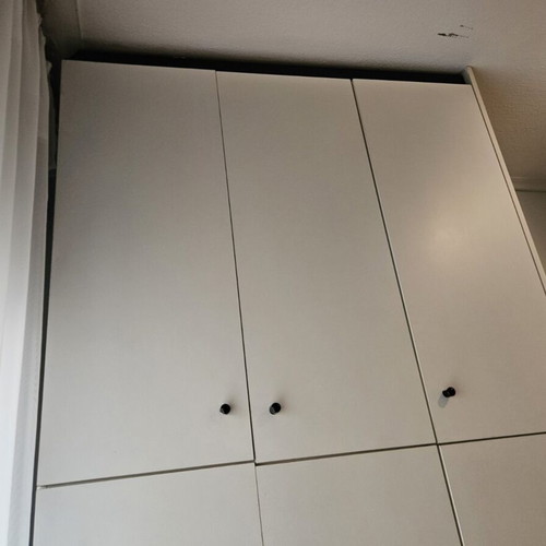 Bedroom wardrobe used with storage spaces, modern design, white doors