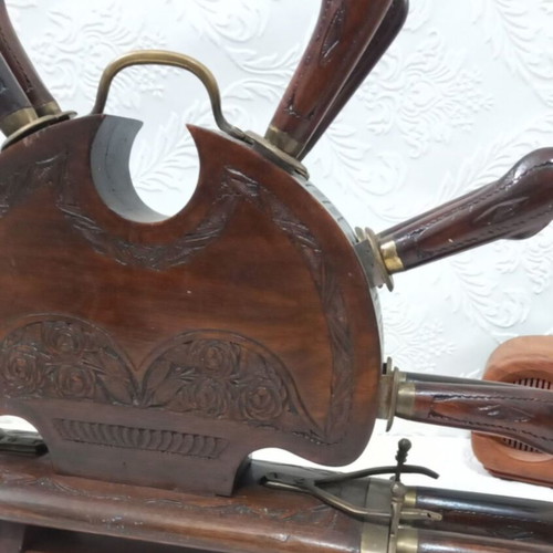 Wooden carved stand with used set of knives and forks