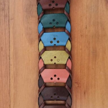 Colorful woven belt in warm shades made of faux leather, like new
