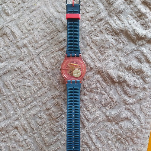 Swatch unicex watch used with transparent case and pink plastic strap