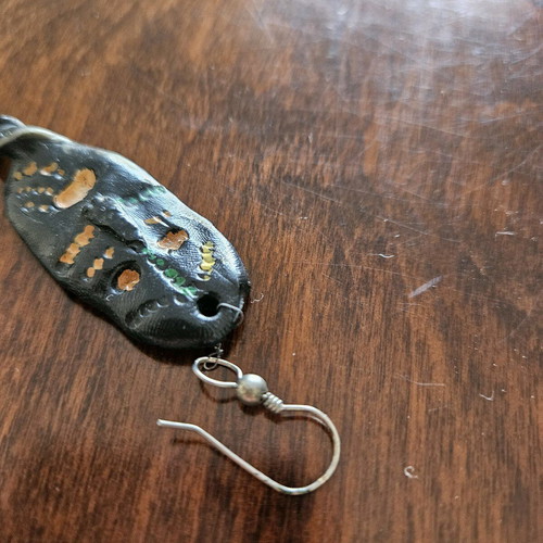 Black earring used, totem-inspired with multicolor pattern