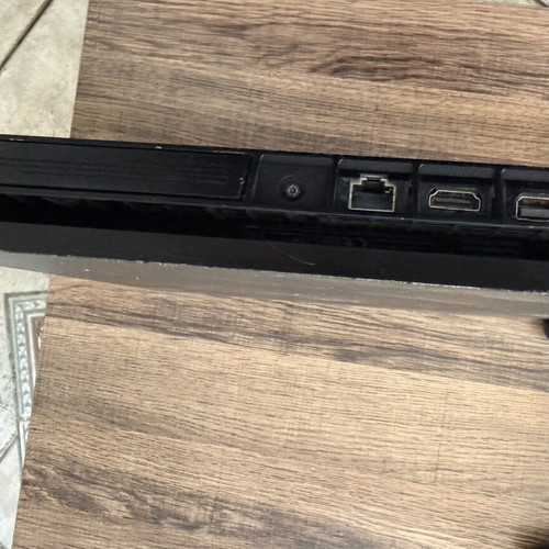 PlayStation 4 Slim 500GB used with 2 DualShock 4 controllers and accessories