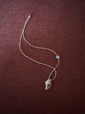 Handmade necklace with natural shell and blue bead