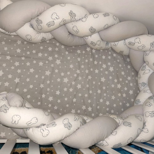 Baby braided crib bumper used in gray and white