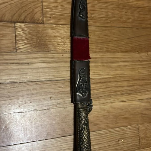 Traditional collectible knife mid-century with carved handle and sheath used