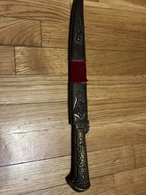 Traditional collectible knife mid-century with carved handle and sheath used