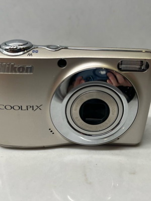 Nikon Coolpix L22 digital camera used with battery door damage