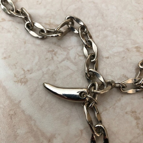 Necklace with plastic and metal fangs