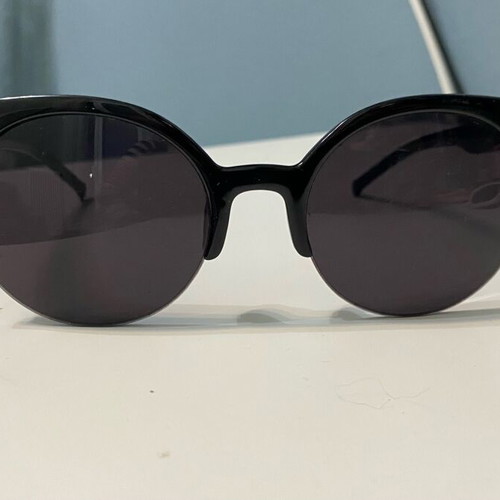 Sunglasses used with black frame and round shape
