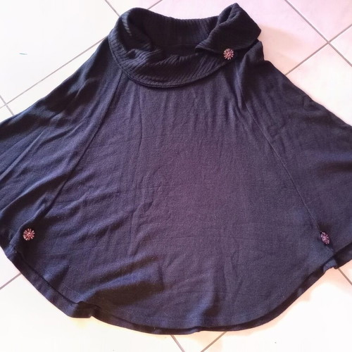 Black poncho like new, one size with details on sleeves and neck