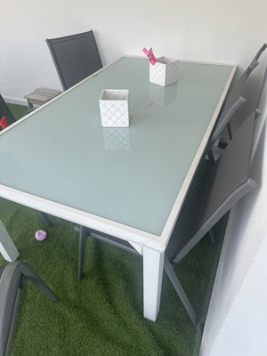 Glass garden dining table with 6 grey chairs used