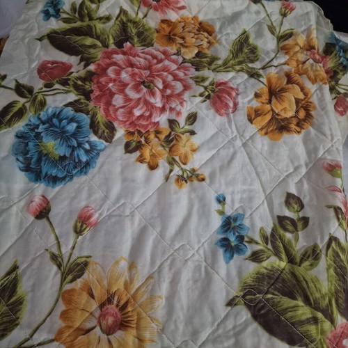 Vintage quilt with floral design, cream background