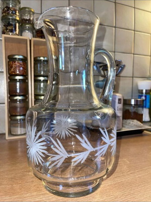 Vintage glass pitcher with engraved floral design