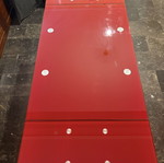 Extendable dining table with red glass surface like new