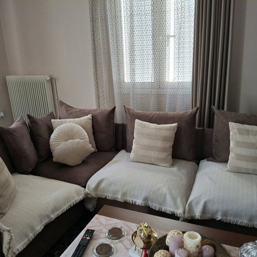 Corner sofa four-seater used, brown without covers and beige cushions
