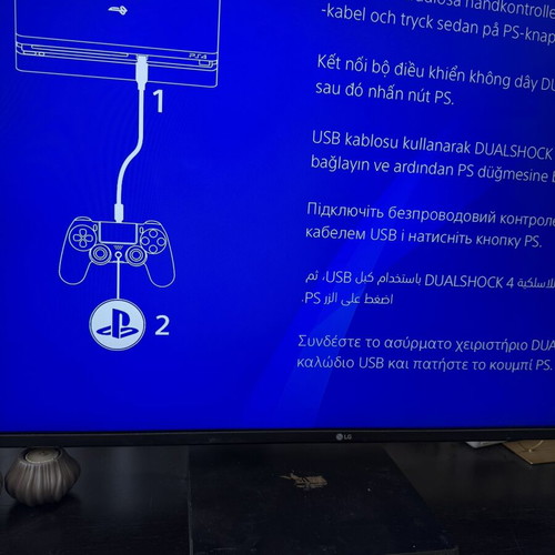 PlayStation 4 Slim 500GB used with 2 DualShock 4 controllers and accessories