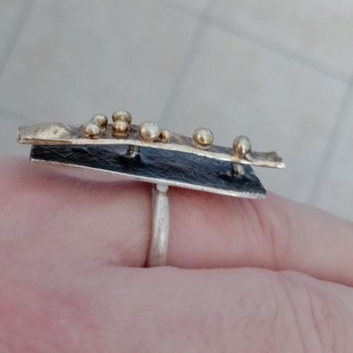 Statement two-tone ring used with layers, silver and gold colors