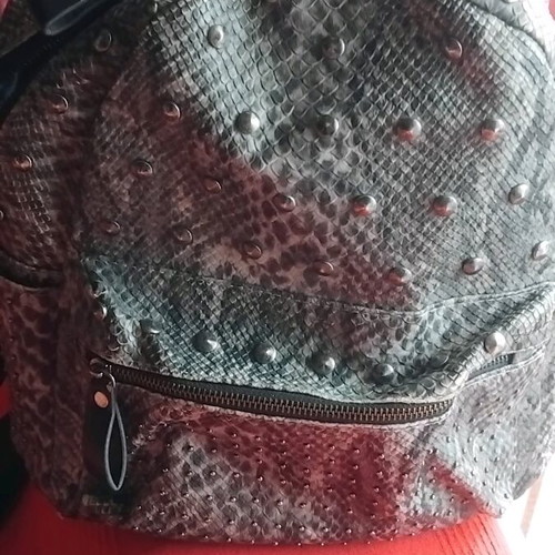 Snakeprint backpack used, grey with snake pattern and studs
