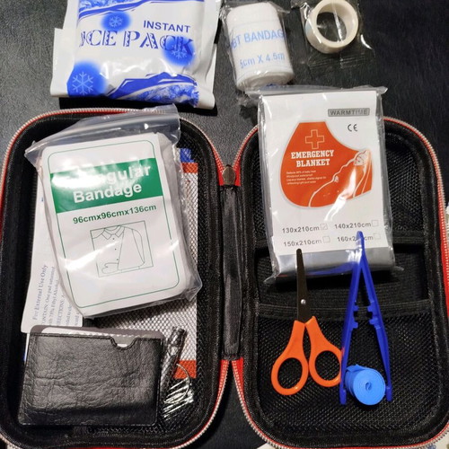 Car first aid kit new, complete in red color