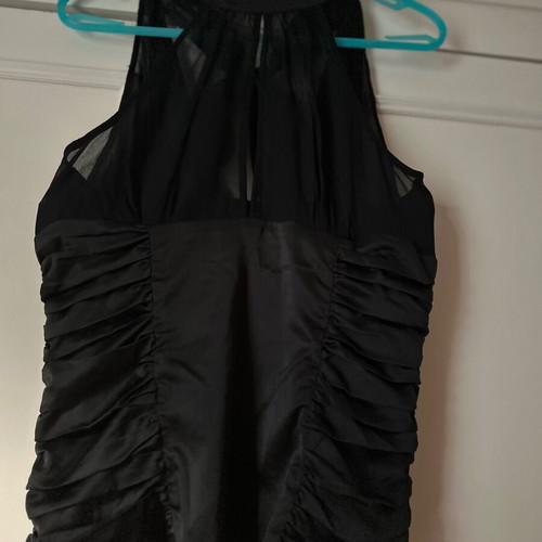 Twentyone L, women's black blouse, made of satin and muslin. The bow at the back.