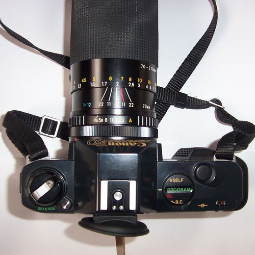 Canon T50 SLR analog camera used with two zoom lenses and flash