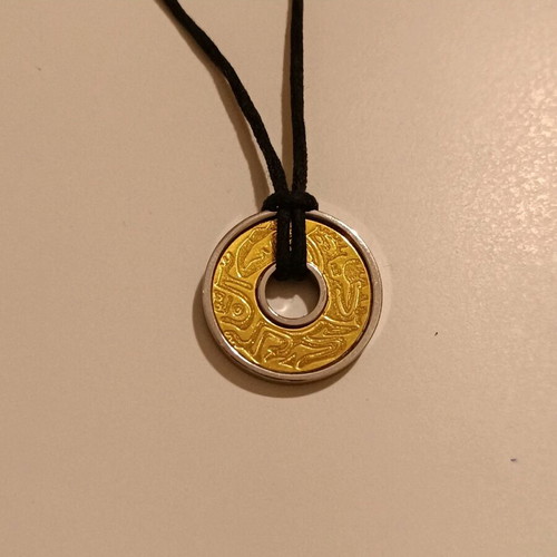 Rebecca pendant necklace used, steel and gold with Polynesian design