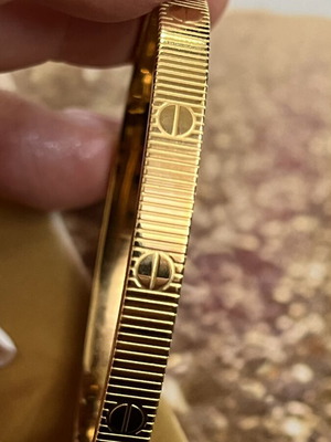 Bracelet new, gold tone stainless steel with embossed details