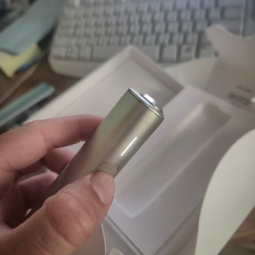 Iqos ILUMA One Gold device used with box and cable
