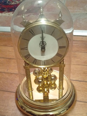 Anniversary clock quartz with glass dome and rotating pendulum, like new