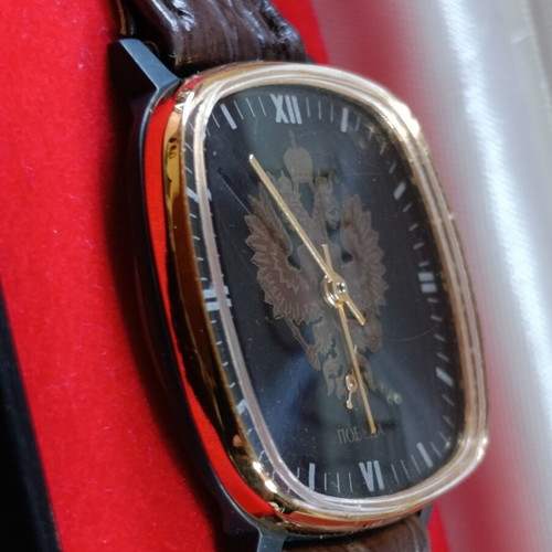 Pobeda vintage Soviet Russian mechanical watch with square case and double-headed eagle emblem