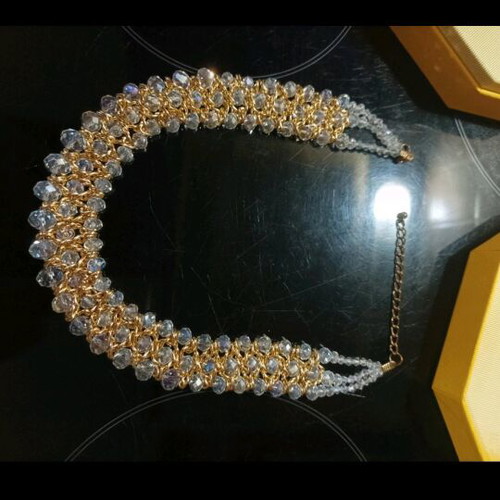 Women's evening necklace like new with gold weave and white stones