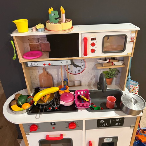 Wooden children's kitchen used with utensils