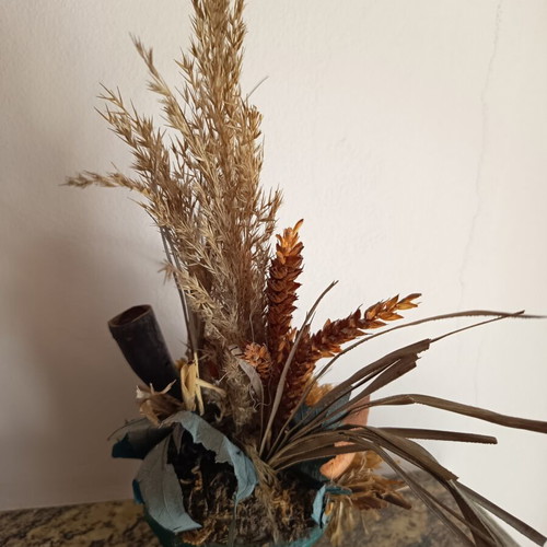 Vintage handmade decorative arrangement with dried stalks used