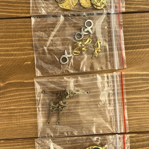 Metal beads and symbols pack like new, 12 bags